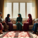Group of Muslim family influence in Muslim marriage and women and one man sitting in a living room, engaged in a thoughtful discussion.